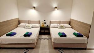 two beds sitting next to each other in a room at Villa Dardona Drvenik in Drvenik