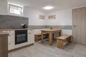 a kitchen with a table and a stove top oven at Apartment For You in Bled