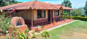 a small house with a red roof at Finca Campestre Villa Carilina in Curití