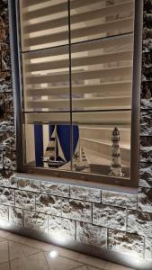a window with a picture of a boat and a lighthouse at Villa Dardona Drvenik in Drvenik