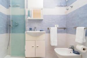 een badkamer met een wastafel, een toilet en een spiegel bij Casetta Lucia in Massa Lubrense
