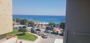 a view of a city with cars parked in a parking lot at Ibiscus Hotel in Rhodes Town