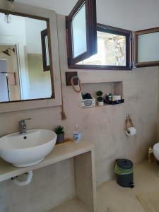 a bathroom with a sink and a mirror at Vaki's country house in Pylos +37 photos