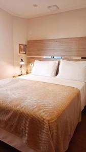 Кровать или кровати в номере Pousada Blumenau