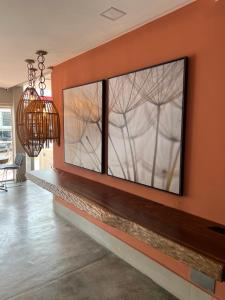 a wall with three large windows in a living room at Pousada Cerrado in Goiânia