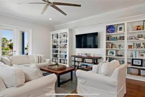 a living room with white furniture and a flat screen tv at Luxurious Modern Townhouse right across beach!! Table Tennis in St Pete Beach