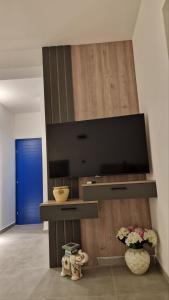 a living room with a flat screen tv on a wall at Villa Dardona Drvenik in Drvenik +9 photos