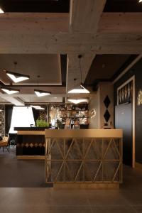 a bar in a restaurant with a counter and chairs at Aparthotel Prestige in Zakopane