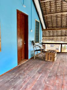 a room with a bench and a blue wall at Milele Lodge in Michamvi