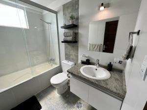 a bathroom with a sink and a toilet and a shower at Acogedor departamento en el corazón de cochabamba in Cochabamba +7 photos