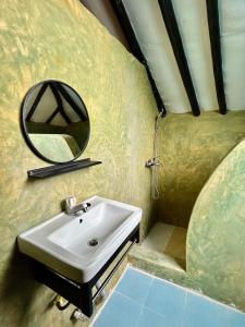 a bathroom with a sink and a mirror at Milele Lodge in Michamvi
