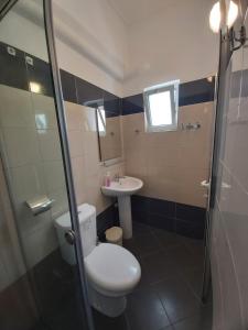 a bathroom with a toilet and a sink at MyKsamil Apartments in Ksamil