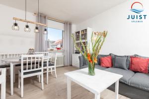 a living room with a couch and a table at Haus Hamburg 181 Wohnung 1 in Juist