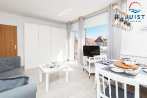 a living room with a couch and a table at Haus Hamburg 181 Wohnung 1 in Juist