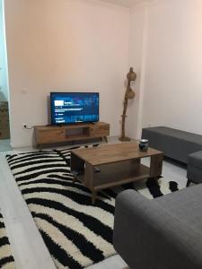 a living room with a television and a coffee table at mumcular apartment in Bodrum City