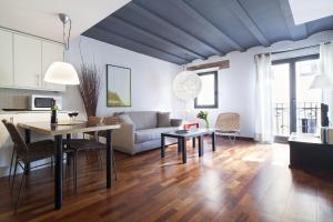 a living room with a couch and a table at Inside Barcelona Apartments Esparteria in Barcelona