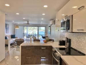 a kitchen with a counter top and a living room at 232B South Finger in Jolly Harbour