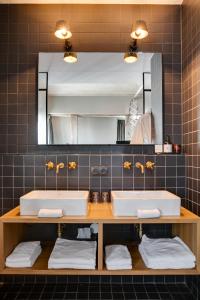 a bathroom with two sinks and a mirror at The Duke Boutique Hotel in Den Bosch