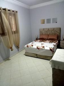 a bedroom with a bed in the corner of a room at Villa sidi Bouzid in El Jadida