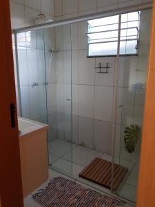 a shower with a glass enclosure in a bathroom at Abrigo Serafina#cama&café in Itamonte