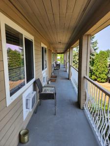 a porch with benches and windows on a house at Grantview Inn in Surrey