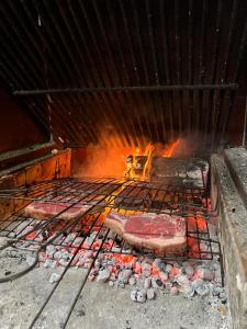 a grill with meat and other food on it at Casa Rural del Saz in Yeste