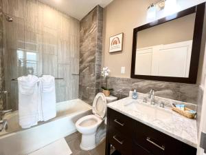 a bathroom with a toilet and a tub and a sink at 503 Bohemian Romance Apartments in center city in Philadelphia