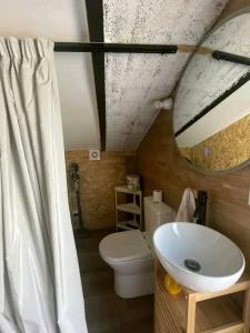 a bathroom with a white sink and a toilet at Arrendar braga in Braga