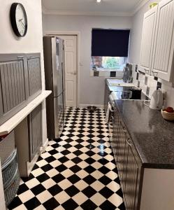 a kitchen with a black and white checkered floor at Antiquated house in Scarborough