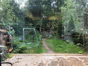 a view of a garden with a swing at Woodcliff in Birkenhead