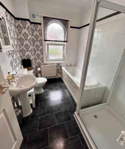 a bathroom with a sink and a toilet and a shower at Antiquated house in Scarborough