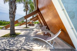 a staircase leading up to a building with a chair and a laptop at Casale Delle Ronde B&B in Latina