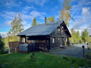 uma casa de madeira com telhado de metal em Villa Breikki, Himos em Jämsä