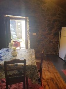 a dining room with a table and a window at Casa da Eduardinha in Góis