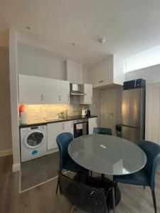 a kitchen with a table and chairs in a kitchen at City Centre Studio Apartment in Dublin