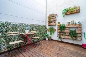 a patio with a table and chairs and plants at Hauzify I Casa d'Anselm Clavé in Calella