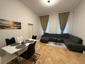 Schöne 2 Zimmer Apartment im Wiener Altbaustil nahe Donaukanal في فيينا: غرفة معيشة مع أريكة وطاولة