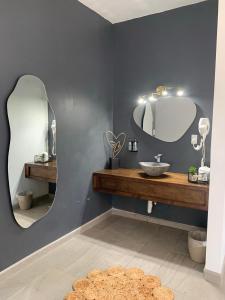 a bathroom with a sink and a mirror at Sol del Valle in Valle de Guadalupe
