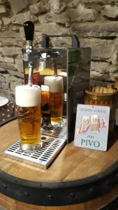a table with two glasses of beer on it at Privát JOZEF in Vrbov
