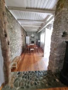 a dining room with a table and a stone wall at Borgo Antico Apartments in Toscolano Maderno