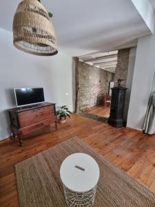 a living room with a table and a fireplace at Borgo Antico Apartments in Toscolano Maderno