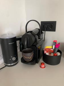 a coffeemaker and a coffee maker on a counter at Belgrade Waterfront Sunshine apartment in Belgrade