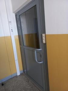 szare drzwi w pokoju z żółtymi ścianami w obiekcie Apartament 7 Piętro w Bydgoszczy