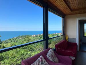 a room with two chairs and a view of the ocean at Önder suit in Rize