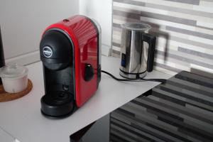 a red and black appliance sitting on top of a counter at Home OLY in Gragnano