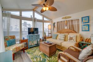 a living room with a couch and a tv at Cozy Waterfront Port Isabel Cottage with Deck! in Port Isabel