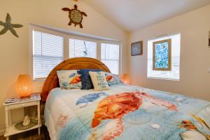 a bedroom with a bed with a turtle pillow and a window at Cozy Waterfront Port Isabel Cottage with Deck! in Port Isabel