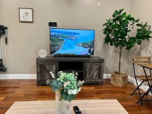 a living room with a television and a table with flowers at 502 Luxury 1BR apartment in center city in Philadelphia