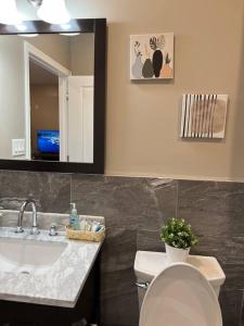 a bathroom with a sink and a toilet and a mirror at 502 Luxury 1BR apartment in center city in Philadelphia