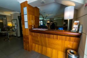 a woman standing at the counter of a restaurant at Hotel Forum in Pompei